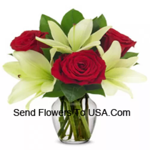 Red Roses And White Lilies With Seasonal Fillers In A Glass Vase